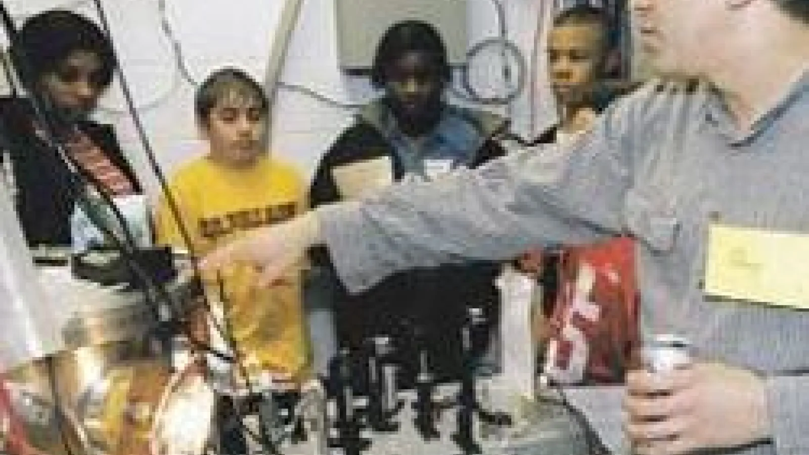 Professor Douglass Schumacher showing lab equipment to students