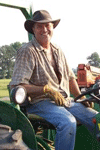 Professor Linn D. Van Woerkom sitting atop a tractor.